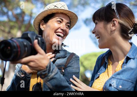 two happy pretty best friends taking photos Stock Photo