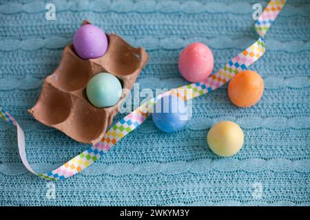 Easter flatlay of Colorful Chalk Eggs on a blue blanket Stock Photo