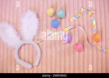 Easter flatlay of Colorful Chalk Eggs on a peach blanket Stock Photo