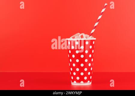 Paper cup with cola and ice over red background, with copy space Stock Photo