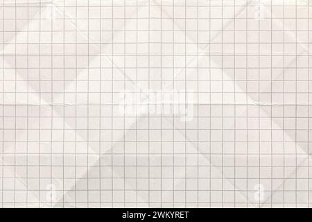 A wrinkled sheet of white grid paper displayed unfolded Stock Photo