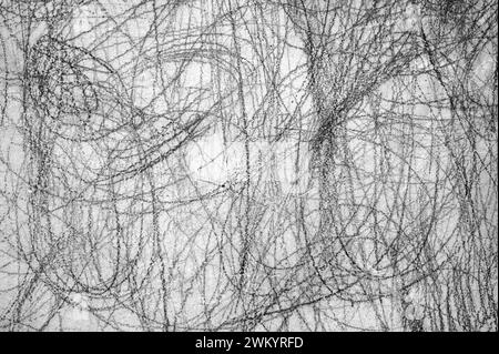 Abstract scribble, scrawl by pencil on the gray wall as texture or background Stock Photo