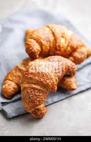 Baked tasty croissants on the kitchen table. Stock Photo