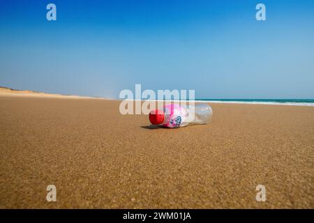 A plastic drink bottle on an otherwise deserted beach on the east coast of India Stock Photo