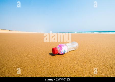 A plastic drink bottle on an otherwise deserted beach on the east coast of India Stock Photo