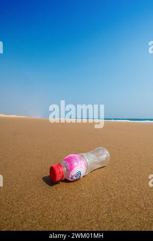 A plastic drink bottle on an otherwise deserted beach on the east coast of India Stock Photo