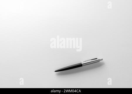 Close-Up of Classic Black and Silver Ballpoint Pen on a White Paper Stock Photo