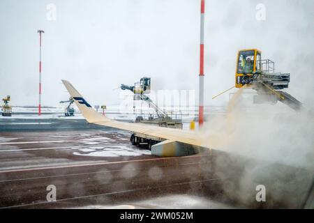 A Finnair plane being de-iced at Helsinki airport Stock Photo