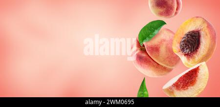 peach with slices and leaves on peach colour background Stock Photo