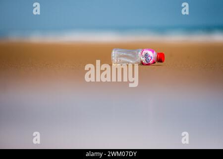 A plastic drink bottle on an otherwise deserted beach on the east coast of India Stock Photo