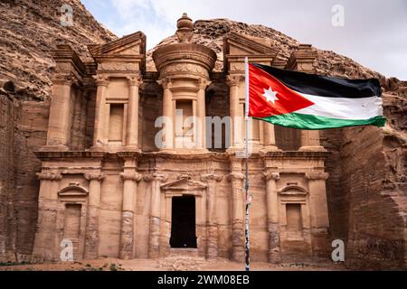 Petra, Jordan. 15th Feb, 2024. The Ad-Deir Monastery with a Jordanian flag in Petra, one of the 7 wonders of the world on February 15, 2024 in Jordan. Photo by Alexis Jumeau/ABACAPRESS.COM Credit: Abaca Press/Alamy Live News Stock Photo