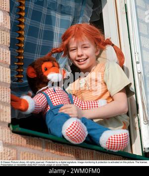 Inger Nilsson. Born in 1959. Swedish child actress known for playing the role of  Pippi Longstocking in the TV series and movies based on the character of author Astrid Lindgren. Here dressed in Pippi clothes and the red hair in  braids. A stuffed animal represents the monkey Herr Nilsson who appeared in the films. 17 February. 1970 *** Local Caption *** Stock Photo