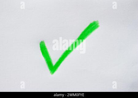 Hand drawn green check mark on white paper Stock Photo