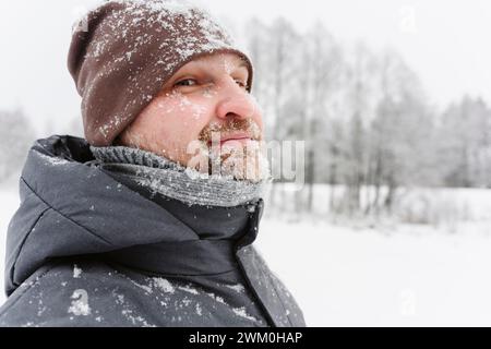 Mature man wearing knitted hat on snowfield Stock Photo