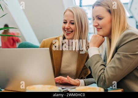 Happy colleagues having business meeting in cafe Stock Photo