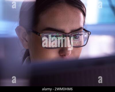 Trader analyzing financial market data on computer Stock Photo
