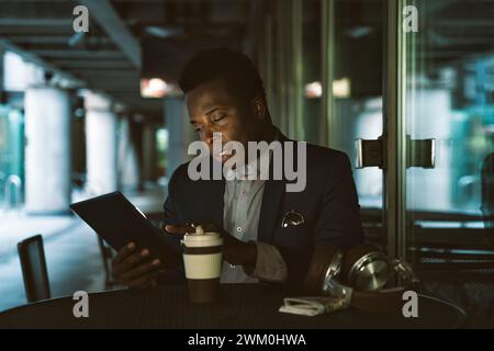 Businessman using tablet PC at cafe Stock Photo