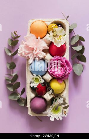 Colorful Easter eggs decorated with flowers on pink background Stock Photo