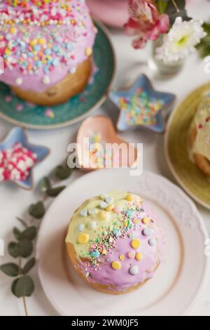 Easter cakes decorated with sprinkles arranged on table Stock Photo