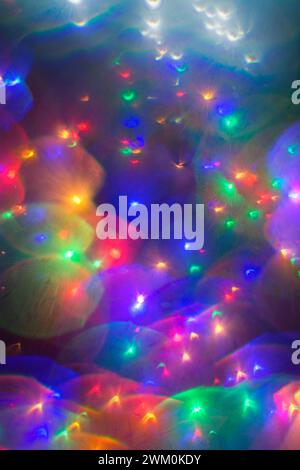 Out of focus Christmas lights, colourful with flare Stock Photo