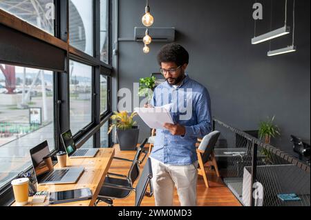 Young businessman examining documents in office Stock Photo