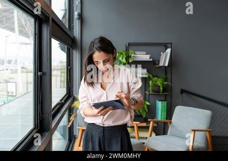 Businesswoman using tablet PC in office Stock Photo