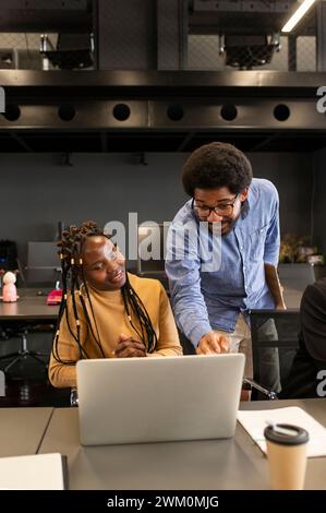 Young businessman discussing over laptop in office Stock Photo