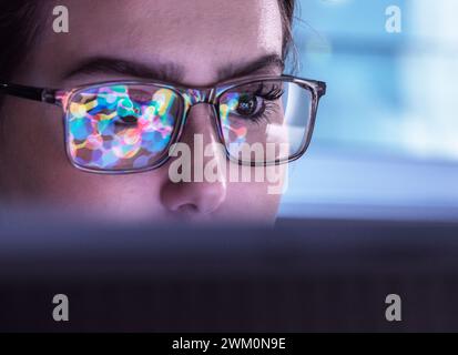 Scientist wearing eyeglasses and analyzing biochemical data on computer Stock Photo