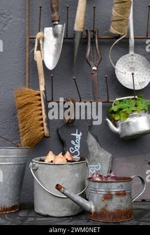 Various gardening tools hanging on wall Stock Photo