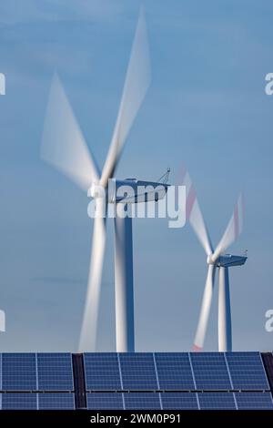 Solar panels and spinning wind turbines Stock Photo