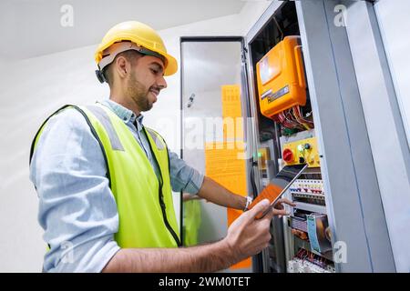 Smiling engineer programming server through tablet PC Stock Photo