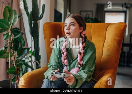 Young woman playing video game at home Stock Photo
