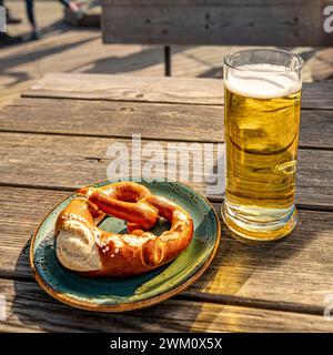 Germany, Bavaria, Oberstdorf, Pretzel, and glass of beer on wooden table Stock Photo