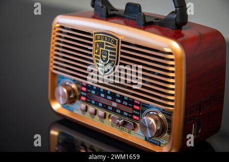 A radio on a table in a dimly lit room, with reflection Stock Photo