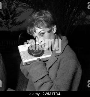 MME4722499 Brigitte Bardot holding a radio, Roma, 1960 (b/w photo); (add.info.: Rome, 1960. actress Brigitte Bardot in her Roman house holding a radio/Roma, 1960.); Photo © Aldo Durazzi/Marcello Mencarini Archives. Stock Photo