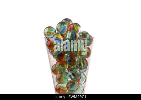 Close-up of a champagne glass filled with glass marbles isolated against a white background Stock Photo