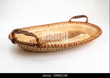 Wicker tray with handles isolated on white background. Clipping path. Stock Photo