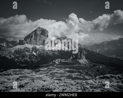 Clouds surround high mountain peaks in black and white in the Italian alps Stock Photo