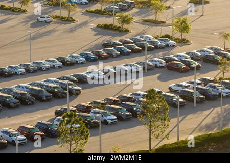 Large parking lot of local dealer with many brand new cars parked for sale. Development of american automotive industry and distribution of manufactur Stock Photo