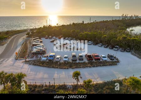 Parking lot at Blind Pass beach on Manasota Key in Englewood. Tourists cars in front of ocean beach with soft white sand in Florida. Popular vacation Stock Photo