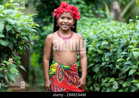 Portrait of a girl from Embera tribe from a village in Chagres national park with traditional tattoos on her face and hibiscus flowers in hair, Panama Stock Photo