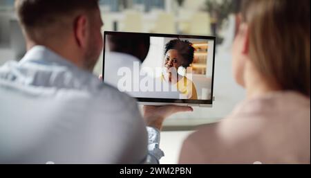 Couple Watching Movie On Tablet At Sofa Stock Photo