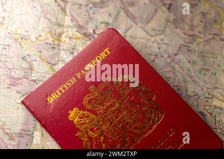 British passport on an old paper map. Stock Photo