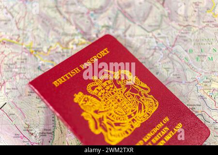 British passport on an old paper map. Stock Photo