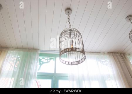 Three ceiling lights suspended by curtains Stock Photo