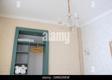 A compact bathroom featuring a wall-mounted light fixture Stock Photo