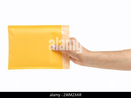 Close-up of hand male offering out an a padded envelope with white background Stock Photo