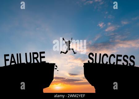 Man jump across text failure to success over cliff on sunset background concept for being successful in job and business. Stock Photo