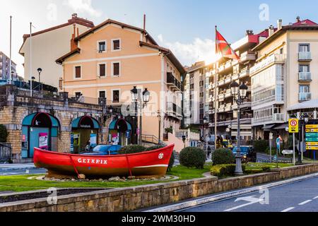 Red boat in the center of the town, a reminder of the seafaring origins of the town of Getaria. Town center. Getaria, Guipúzcoa, País Vasco, Spain, Eu Stock Photo