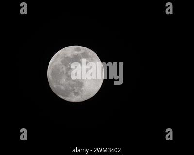 Sheerness, Kent, UK. 23rd Feb, 2024. UK Weather: the almost full Snow Moon seen this evening above Sheerness, Kent.  Credit: James Bell/Alamy Live News Stock Photo